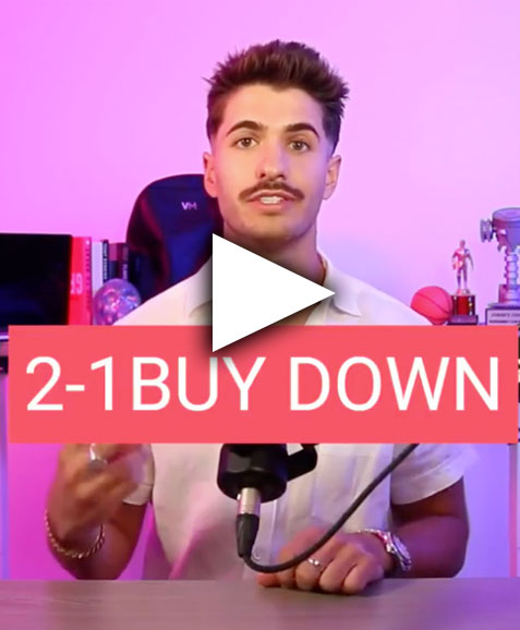 a man sitting at a table with a microphone in front of him.