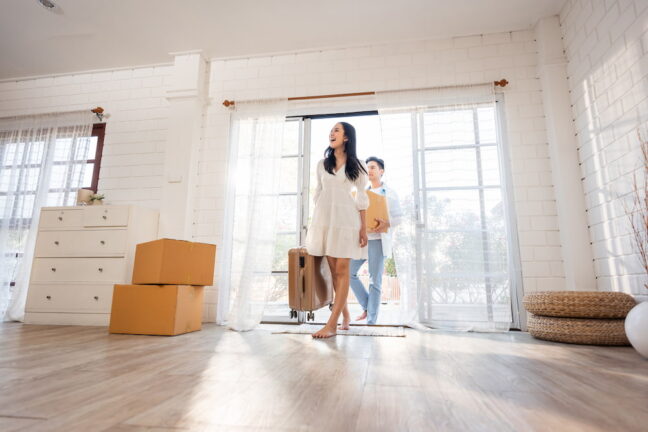 Asian couple moving into new house