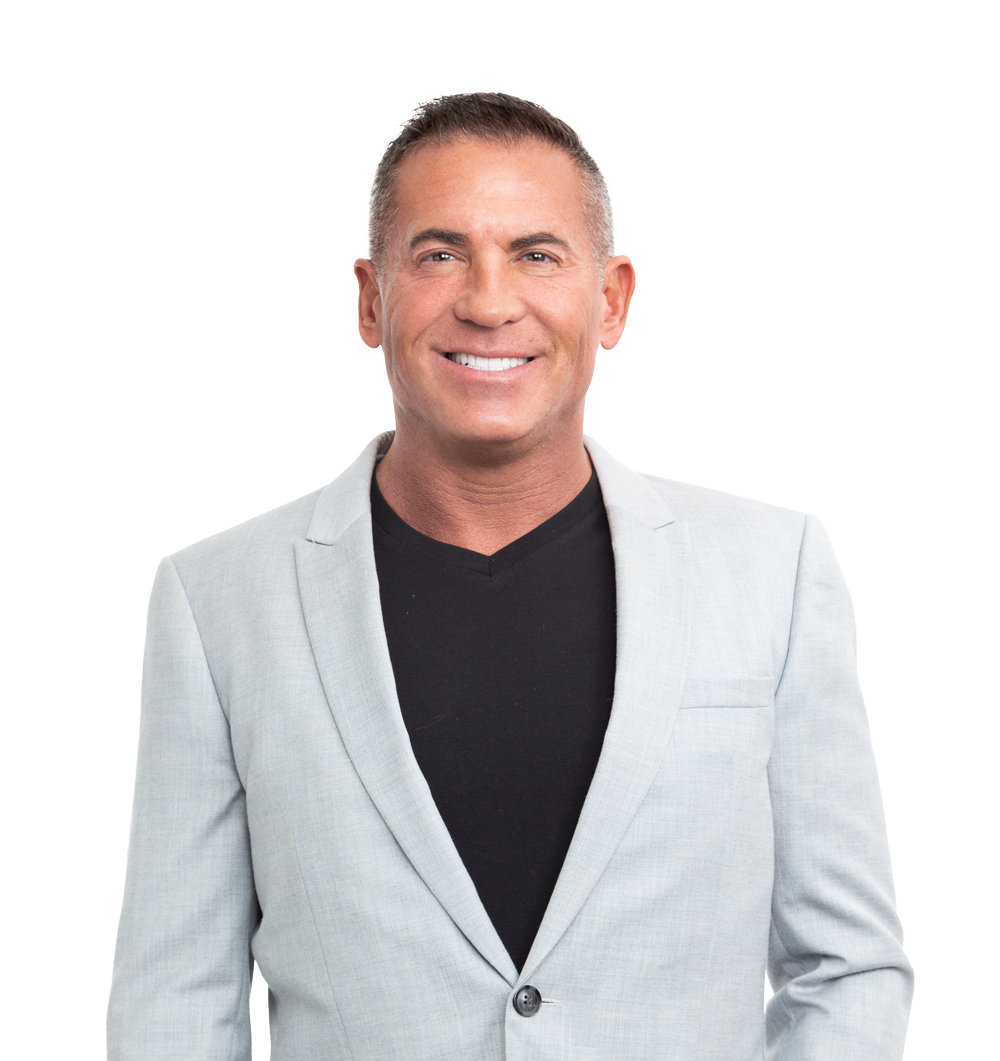 a man in a blue shirt smiles at the camera.