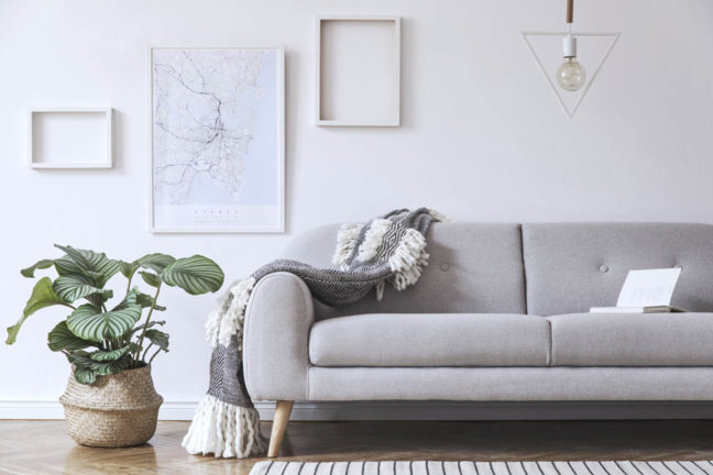 a couch with a blanket on it in a living room