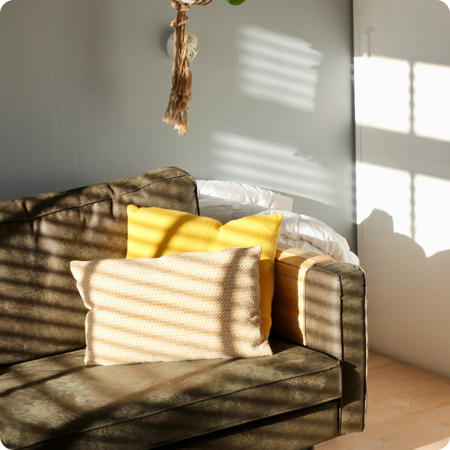 a living room with a couch and pillows